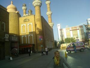Zoe in the long shadow of Urumqi's central mosque.